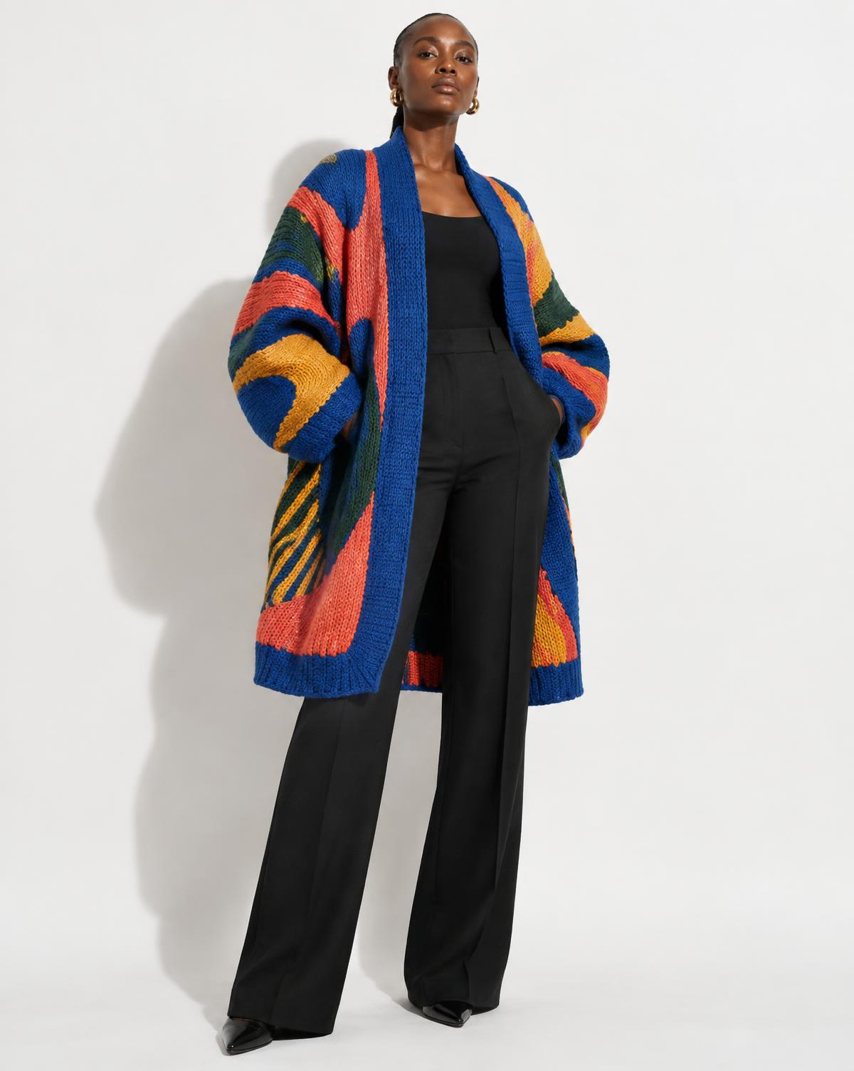 Black African model wearing a colorful sculptural knitted cardigan